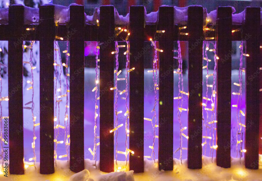 New Year s multi-colored illumination and lights, photo for the background, copy space, blurry, fence New Year s multi-colored illumination and lights, photo for the background, copy space, blurry, fence