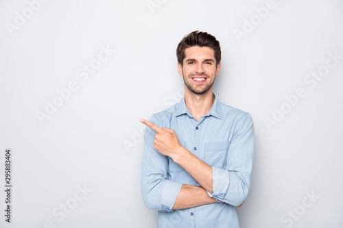 Quadro su tela Portrait of positive cheerful guy promoter point index finger recommend ads sele
