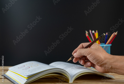 Back to school concept. books on the table with colour pencil in holder