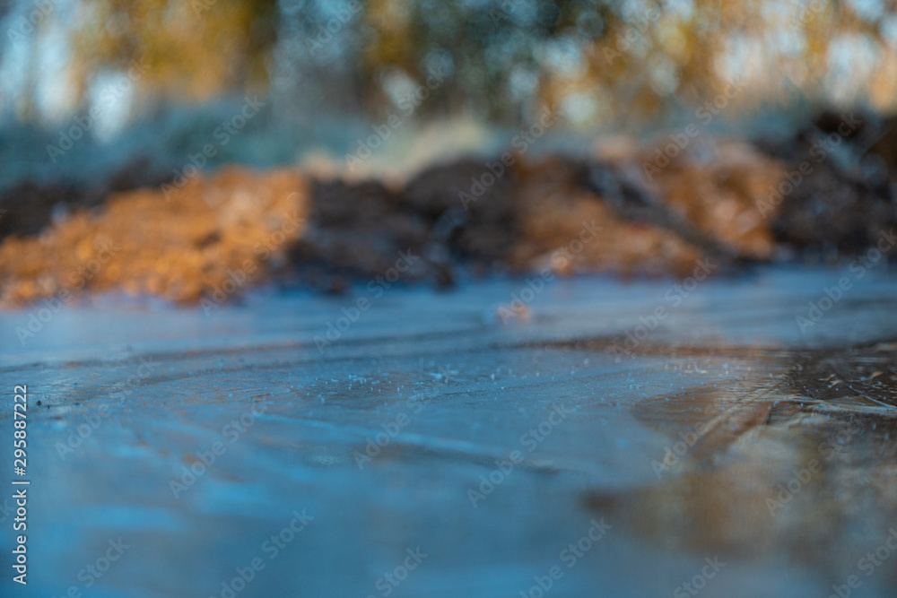 Frozen puddles on mud farm track Frozen puddles on mud farm track
