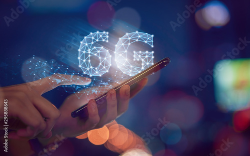 Concept of future technology 6G network, hands press smartphone and high-speed new generation networks screen interface. Wireless systems and internet of things (IOT). photo