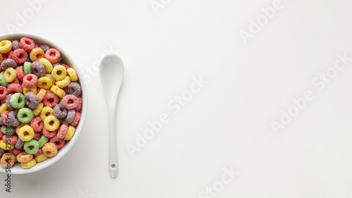 Top view bowl with cereal and plastic spoon