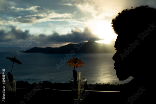 black man silohuette at sunset on the beach photo