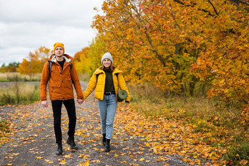 couple of hikers with backpacks hiking in forest