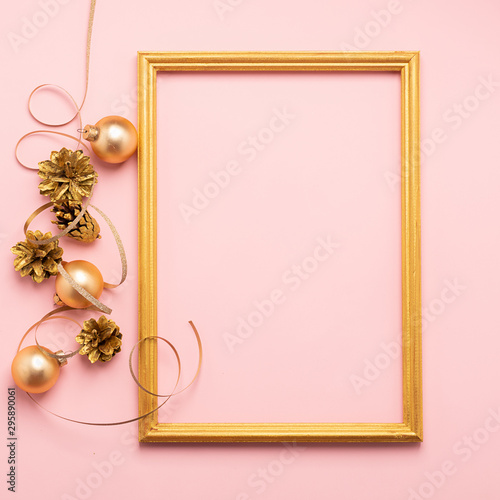 New Year Christmas frame layout balloons streamers shiny cones of gold color pink background. Holiday concept. Flat lay.