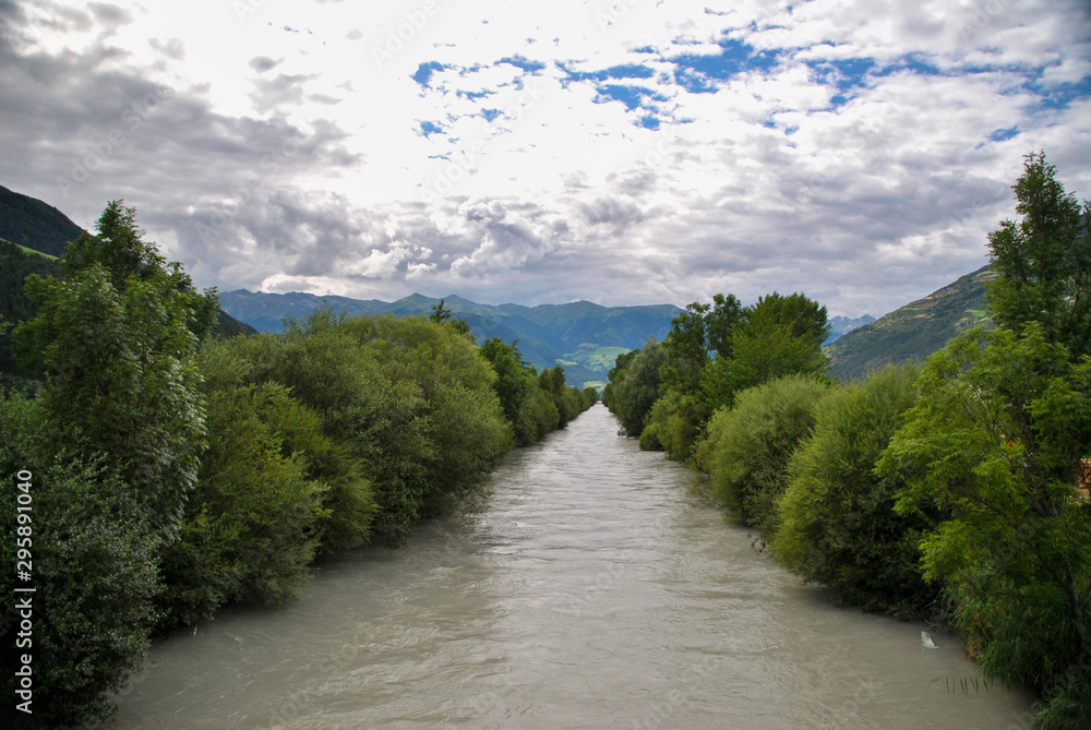 mountain river with trees and clouds