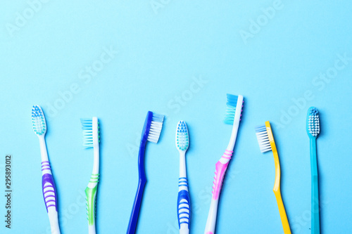 Toothbrushes on a colored background top view. Oral hygiene.