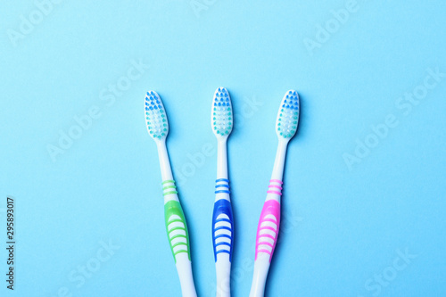 Toothbrushes on a colored background top view. Oral hygiene.