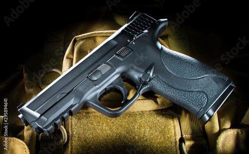 Fotografie Semi auto handgun on tan material