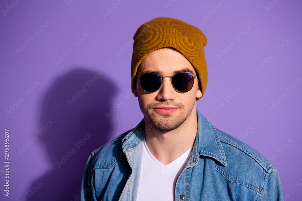 Close up photo of serious confident cool hipster candidly staring into camera through sunglass isolated over bright background Close up photo of serious confident cool hipster candidly staring into camera through sunglass isolated over bright background