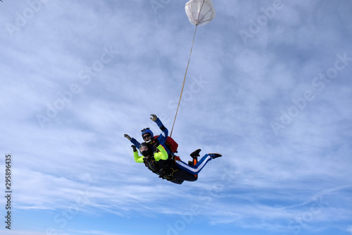 Skydiving. Tandem jump. An instructor and a passenger are flying in the sky.