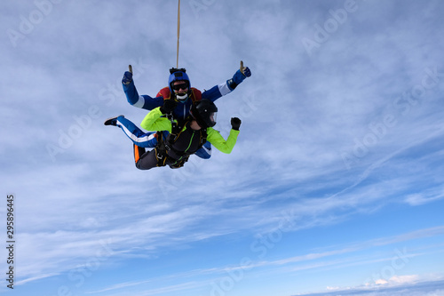 Skydiving. Tandem jump. An instructor and a passenger are flying in the sky.