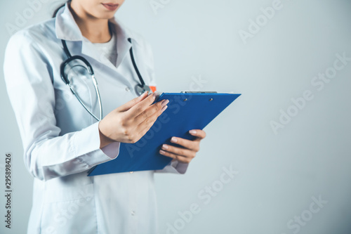woman doctor hand documant on gray background photo