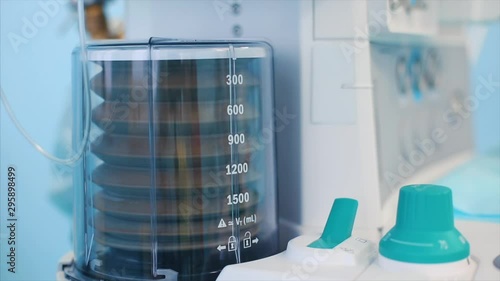 Close up view of anaesthesia machine ventilator and patients monitor inside the operating room. Close-up, blurred background, blue light.