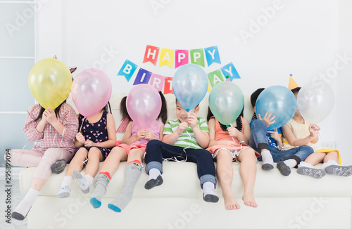 Canvas Print asian children group playing helium balloon in birthday party, they holding balo