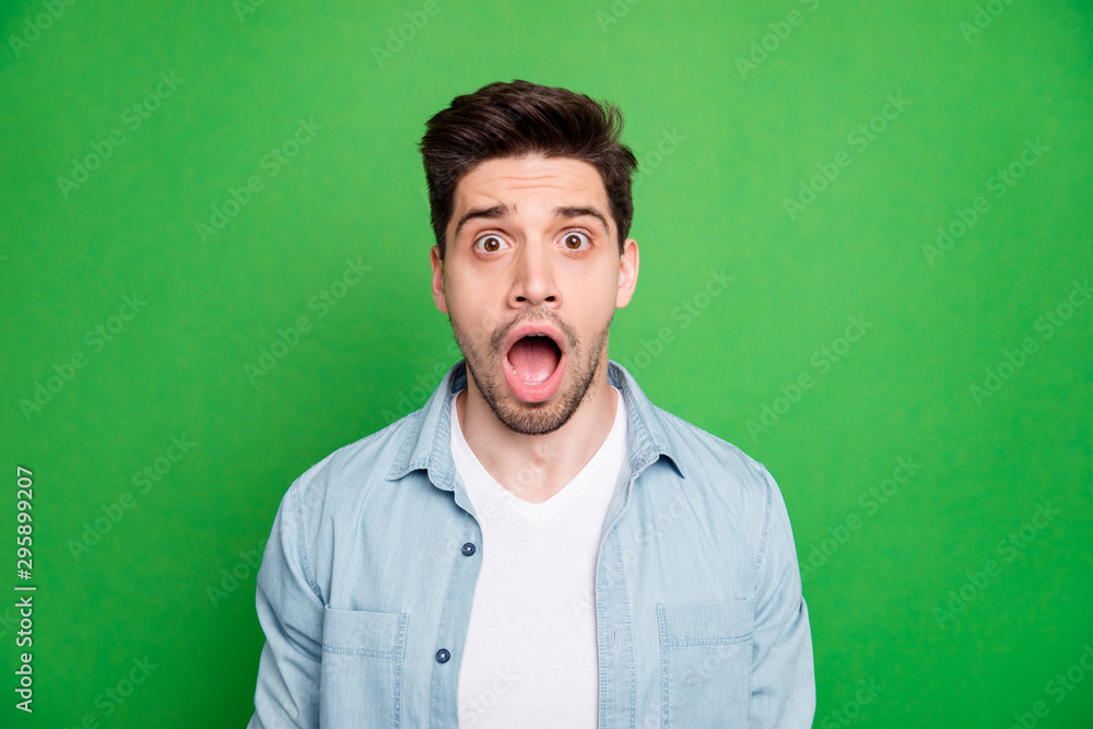 Portrait of crazy mad frightened guy screaming with terror seeing sales ceased wearing white t-shirt isolated over green vivid color background Portrait of crazy mad frightened guy screaming with terror seeing sales ceased wearing white t-shirt isolated over green vivid color background