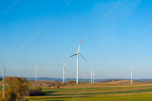 Wind turbines generating electricity. Electrical windmills.