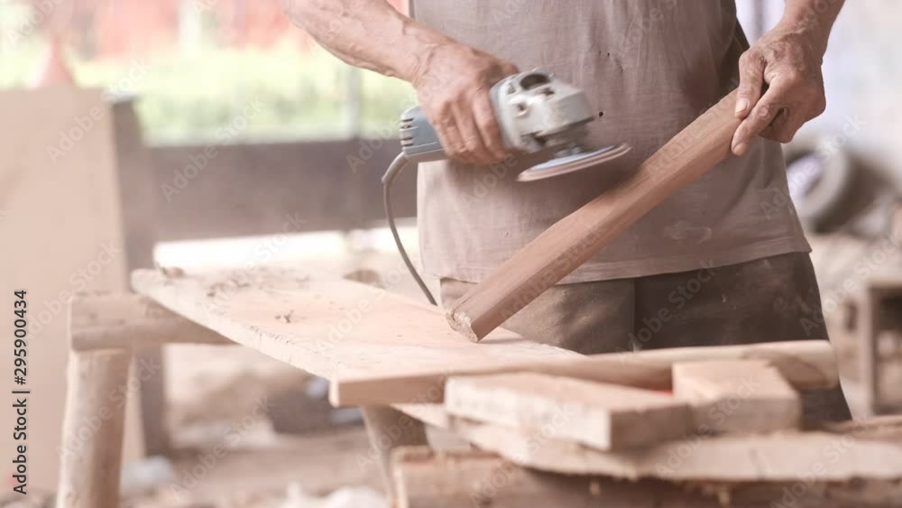 Close up of craftsman use polishing machine for wood working of ax handle. Close up of craftsman use polishing machine for wood working of ax handle.
