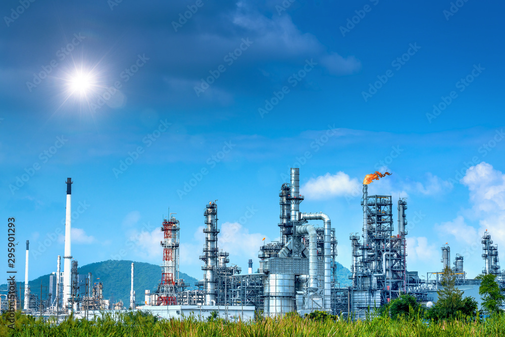 Obraz premium Close-up view Oil and gas industrial refinery zone,Detail of equipment oil pipeline steel with valve from large oil storage tank at cloudy sky. -image