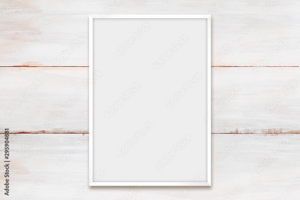 White photo frame on a wooden wall