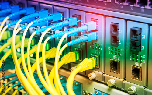 Fiber Optic cables connected to optic ports and UTP, Network cables connected to ethernet ports.