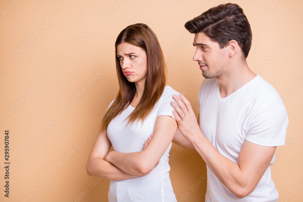 Close-up portrait of his he her she nice attractive couple wearing white t-shirt brunet guy supporting naughty red redhair girl isolated over beige pastel color background Close-up portrait of his he her she nice attractive couple wearing white t-shirt brunet guy supporting naughty red redhair girl isolated over beige pastel color background
