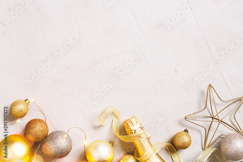 Christmas festive background with golden christmas balls, confetti and champaign bottle