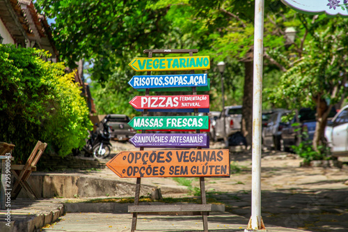 Pirenópolis, Goiás, Brazil, October 19, 2019: Passi Flora, a vegetarian restaurant, on the sidewalk of natural stones, signs suggesting vegetarian, vegan and artisan dishes in the historic city.