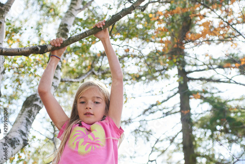Child brave cute girl climbing on tree © Petr Bonek