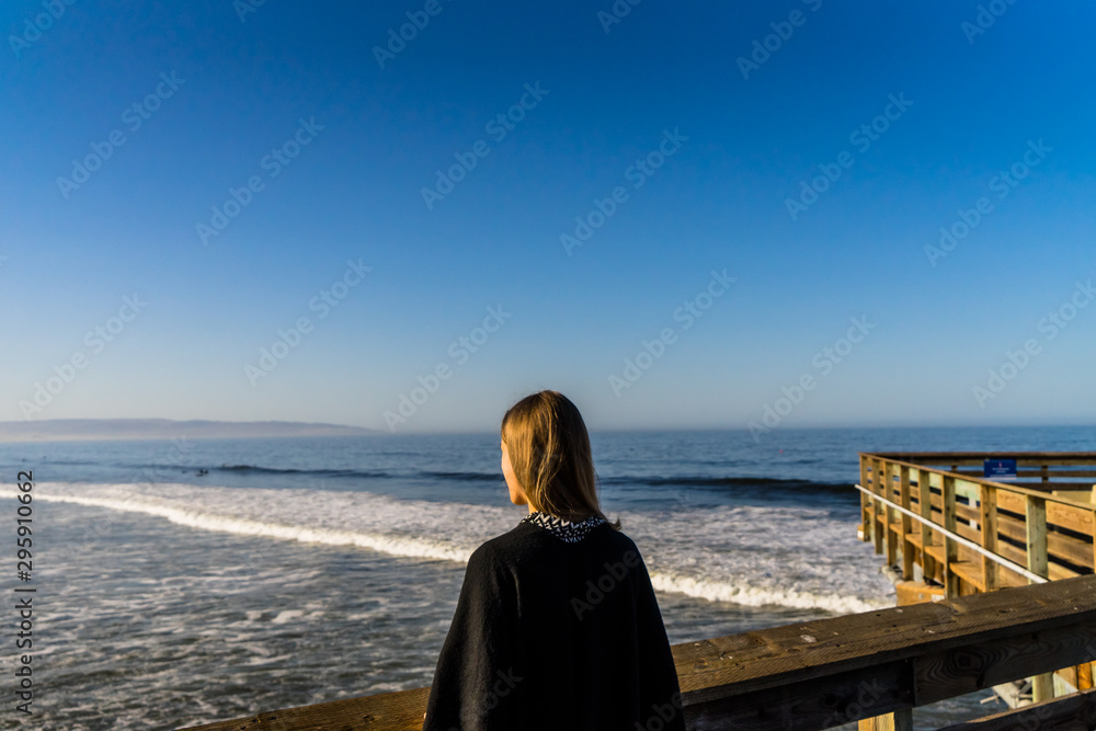 Beautiful girl looking over the pacific ocean in California Beautiful girl looking over the pacific ocean in California