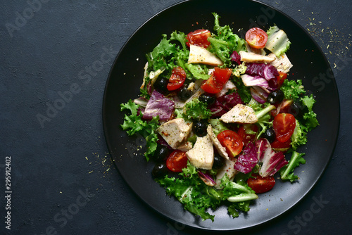 Vegetable salad with chicken and spicy citrus dressing. Top view with copy space.