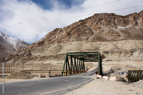 View landscape with road bridge crossing sindhu river at Diskit - Turtok Highway and Pangong lake road go to Pangong Tso high lake while winter season at Leh Ladakh in Jammu and Kashmir, India