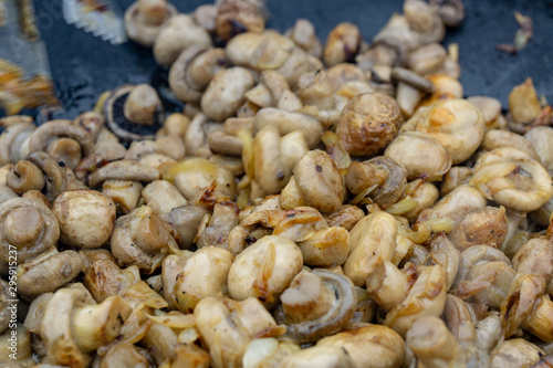 Mushroom fried in a pan with sunflower oil and onion