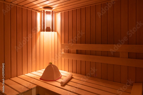 Wooden empty sauna room interior as background. towel and hat for the sauna