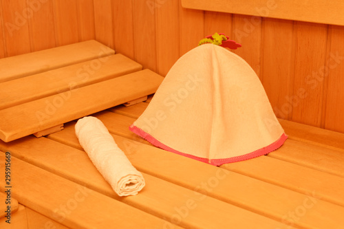 Wooden empty sauna room interior as background. towel and hat for the sauna