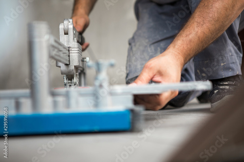 A construction worker uses a ceramic cutting machine