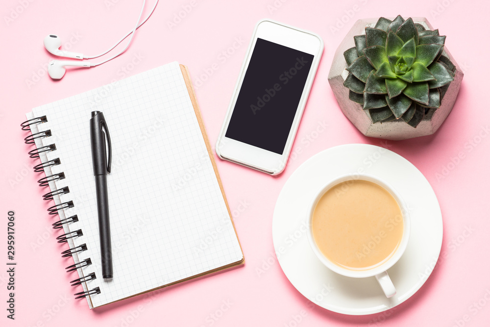 Freelance workplace with notepad, coffee cup, succulent and mouse on pink Freelance workplace with notepad, coffee cup, succulent and mouse on pink