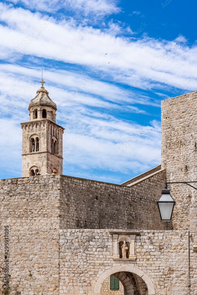 Old city walls in historic Dubrovnik city, Dalmatia, Croatia, blue Adriatic Sea and blue summer sky, popular touristic destination