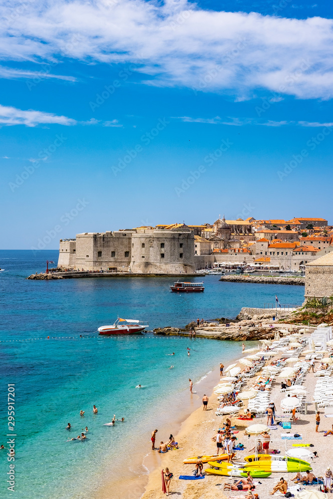 View on old city walls in background and Banja beach in front, Dubrovnik city, Dalmatia, Croatia, summer day, Adriatic Sea, popular touristic destination