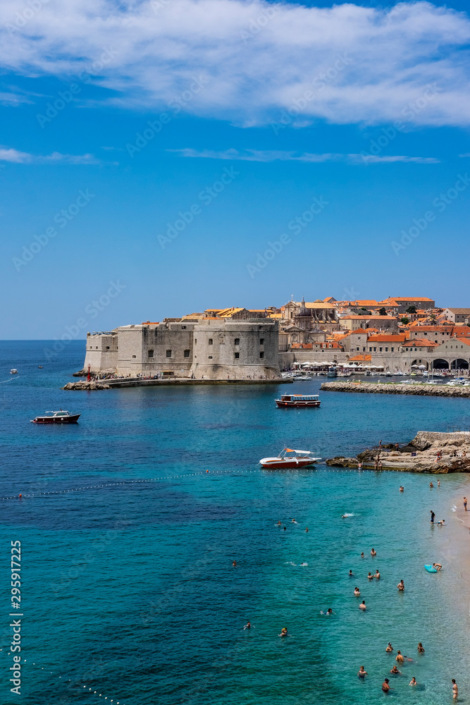 Old city walls in historic Dubrovnik city, Dalmatia, Croatia, emerald Adriatic Sea and blue summer sky, popular touristic destination