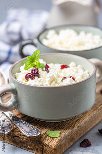 Cottage cheese with dried cranberries in a bowl.