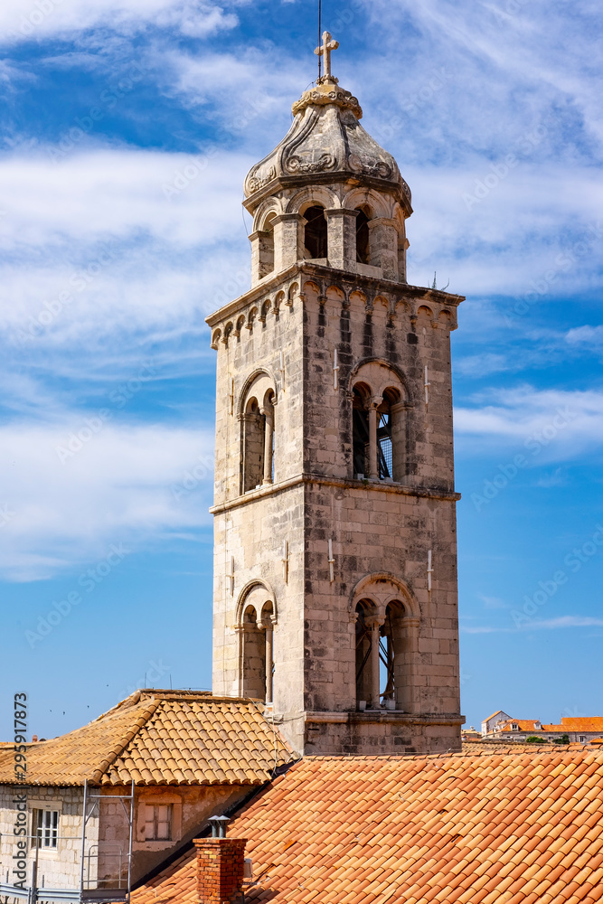Bell tower in the historic centre of Dubrovnik, Dalmatia, Croatia on blue summer day, the most popular touristic destination