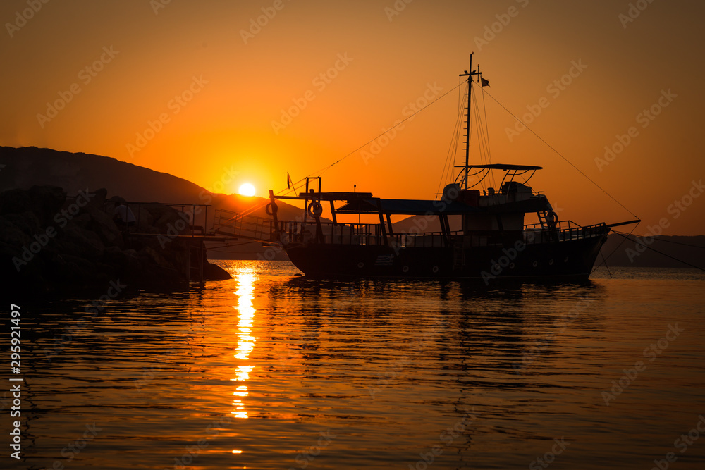 The Fisherman preparing for Sailing for fish at sunrise in sea in the morning in Greece. Beautiful sun reflection.