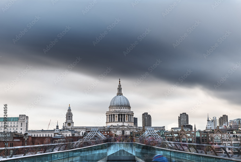Crowds over a bridge in London with St Paul's Cathedral in the background