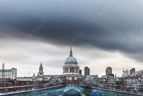Fototapeta Naklejka Na Ścianę i Meble -  Crowds over a bridge in London with St Paul's Cathedral in the background