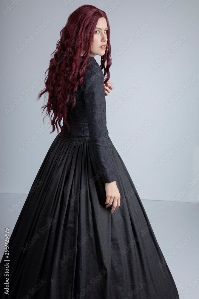 Long-haired Victorian woman in black ensemble