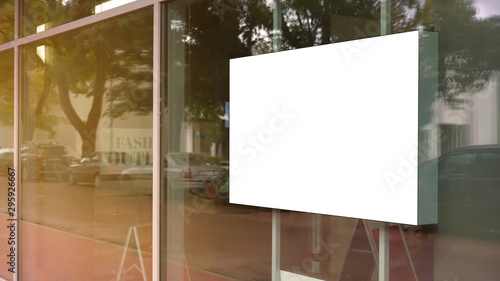 Canvas Print empty white poster frame on glass of showcase window of shopping mall fashion ou