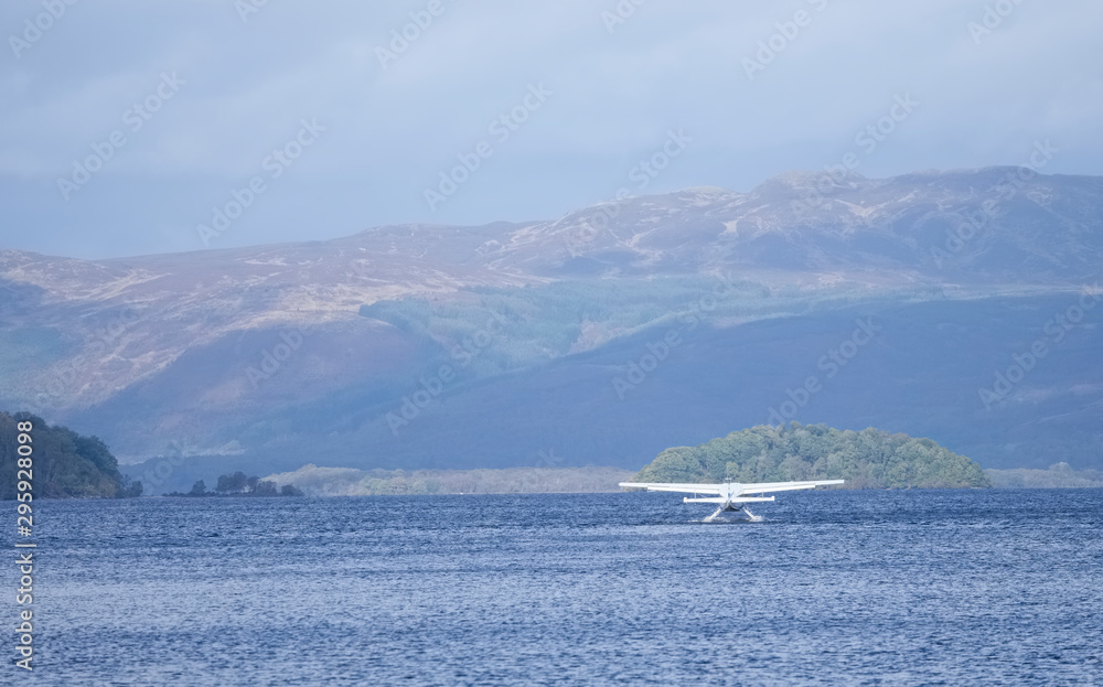 Sea plane landing on lake at Loch Lomond Scotland