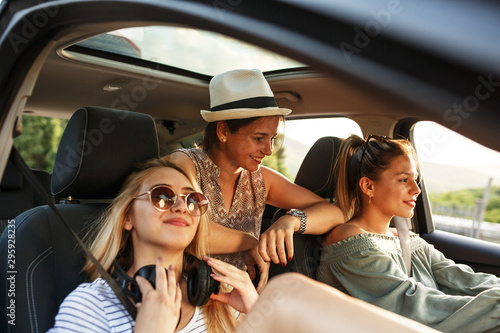 Group of best female friends travel together.They drives a car and making fun.Summer adventure. © BalanceFormCreative