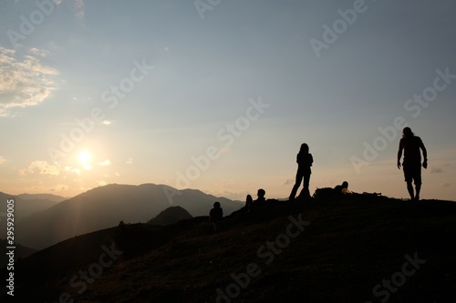 Black silhouette of tourists waiting for sunset on peak Lomis Mta in Borjomi-Kharagauli National Park  Georgia. 
